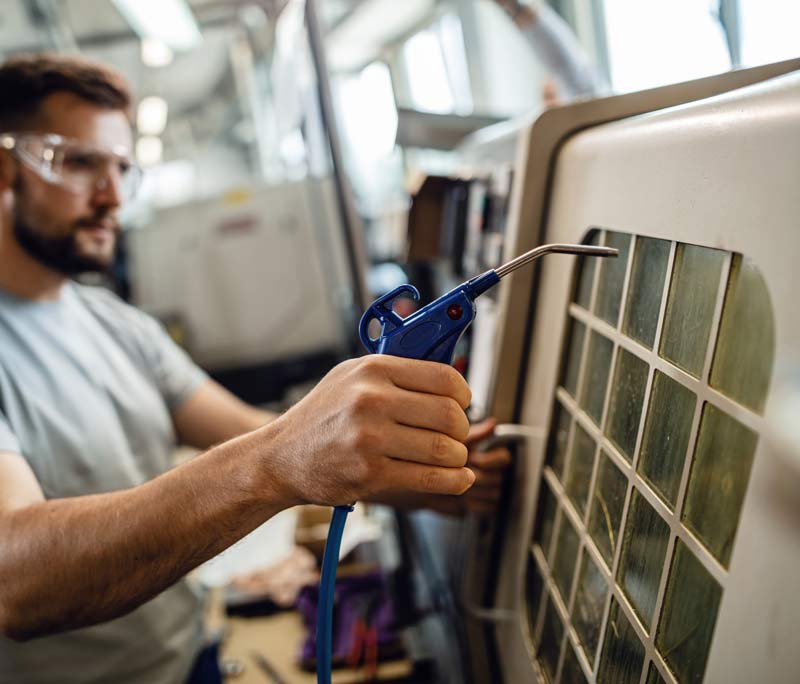 HVAC technician servicing a condenser coil in the field, the kind of on-site work our HVAC marketing and call answering system supports